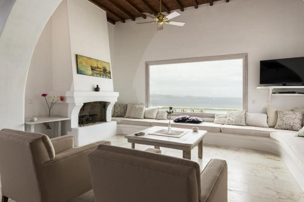 Bright living room with a perfect view of the Aegean Sea, Mykonos luxurious villa for rent, Greece.