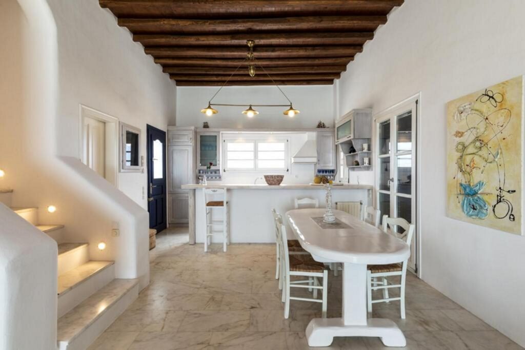 Elegant modern kitchen and a dining room in an exceptional Mykonos villa for booking.