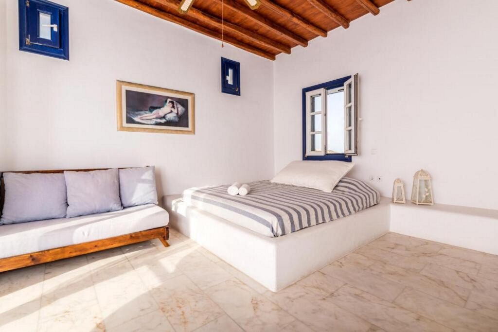 Amazing bedroom with wooden details in Mykonos finest villa for rent.
