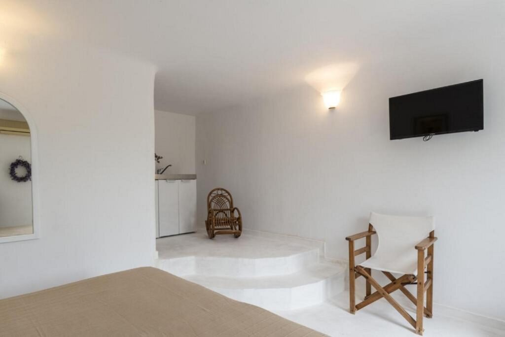 Rocking chair in a bedroom of lavish Mykonos villa for rent.