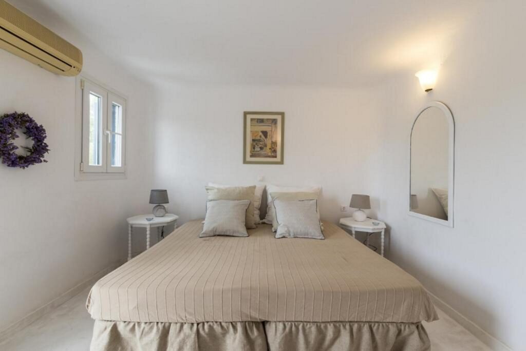 Large cozy bed and spacious bedroom in Mykonos rental villa.