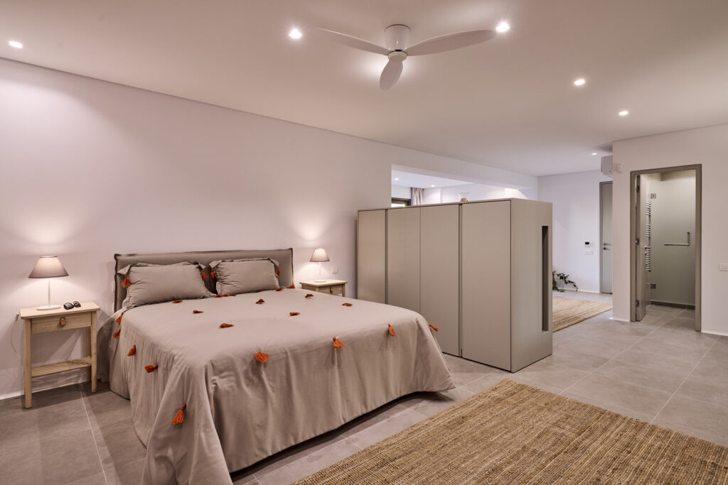 Lavish bedroom with soft colors in Mykonos top villa for rent.