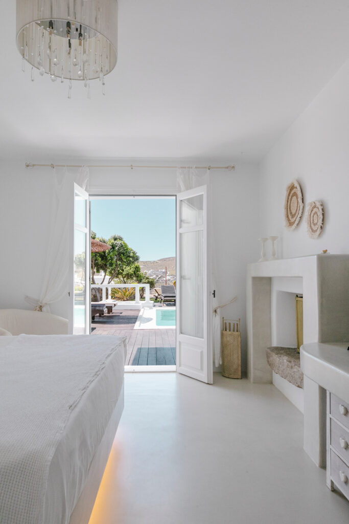 Luxurious bedroom with an exit to a terrace and swimming pool in Mykonos top rental villa.