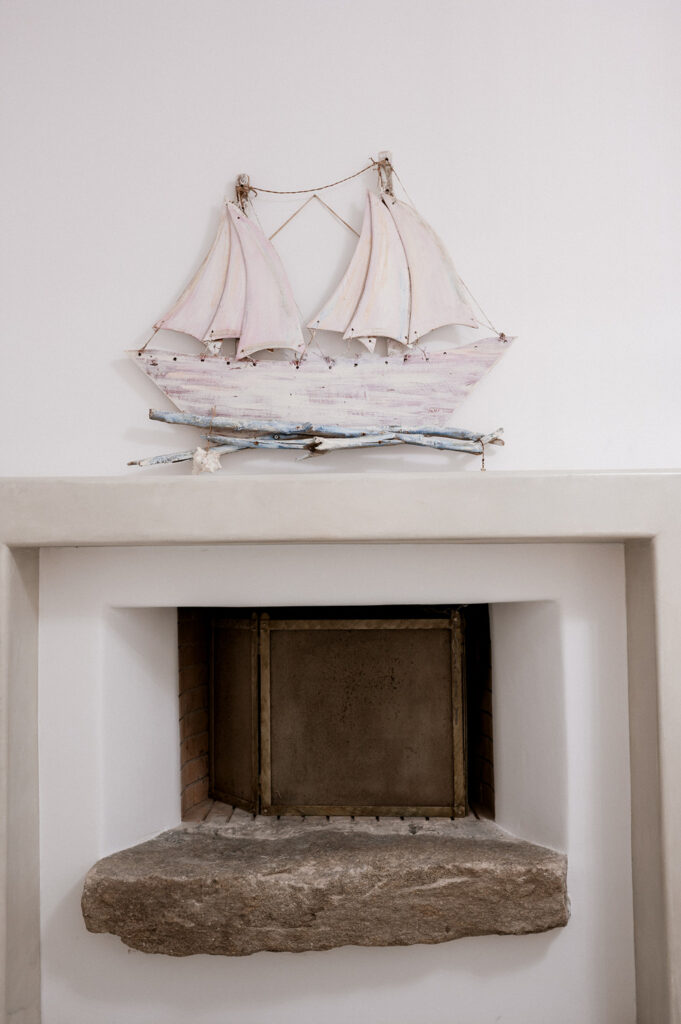 Fireplace and boat ornaments - attention to detail in Mykonos finest villa for booking.