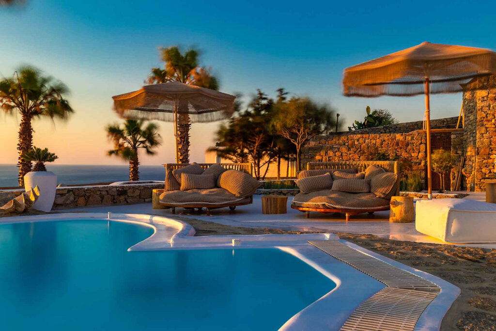 Luxurious sun beds and infinity pool in Mykonos lavish villa for rent.