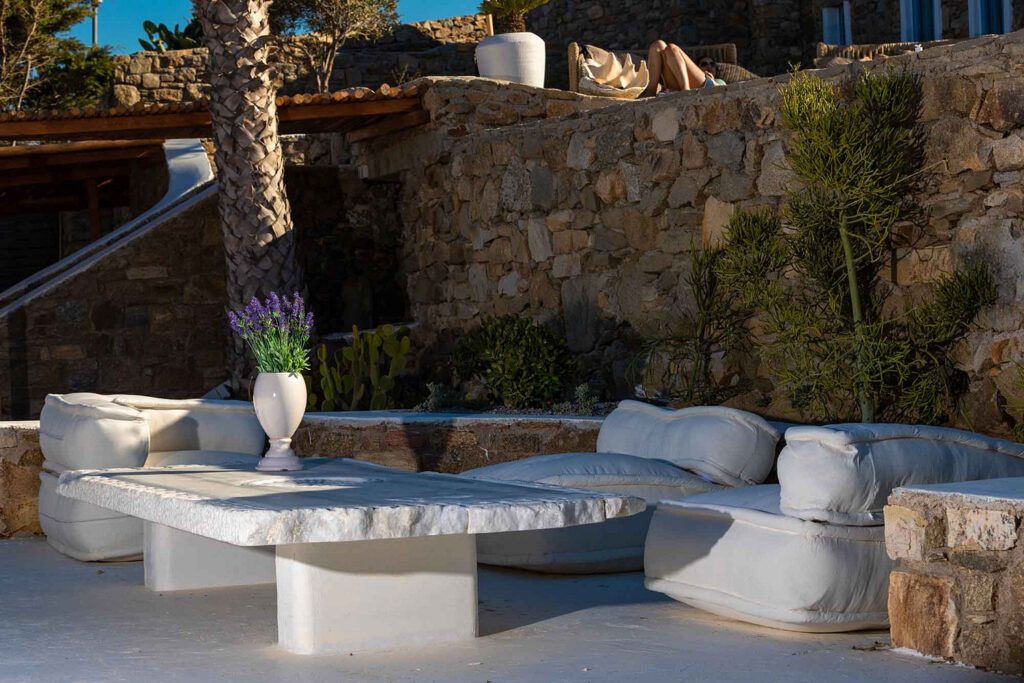 Stunning garden with cozy sofa in Mykonos finest villa for rent.