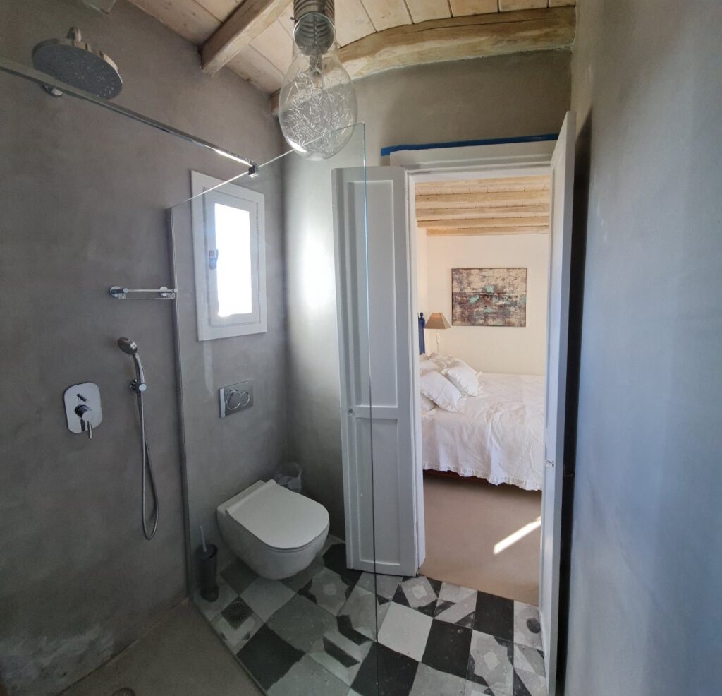 Luxurious bathroom and bedroom in Mykonos' finest villa for rent.