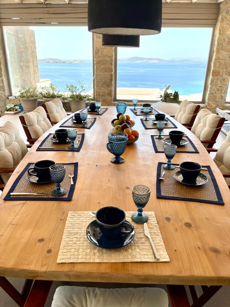 Dining room designed with a stunning view in luxury villa for rent, Mykonos, Greece.