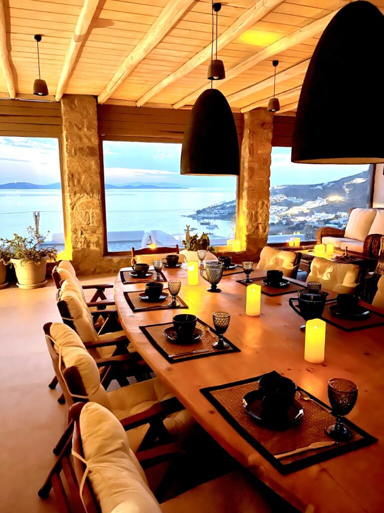 Modern living room with wooden furniture in Mykonos lavish rental villa, Greece.