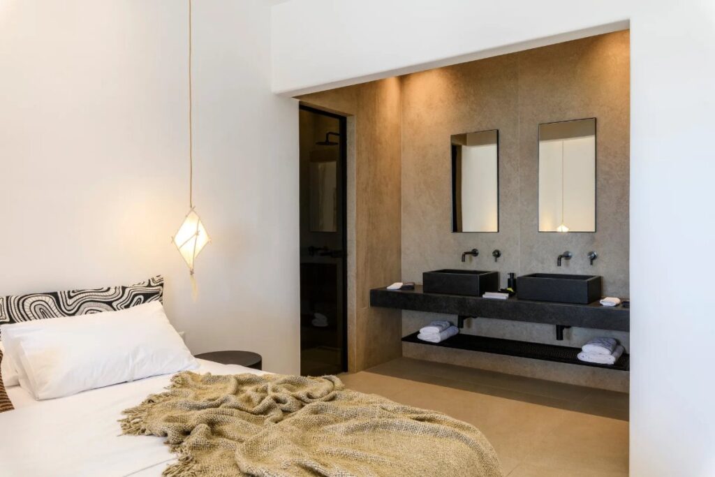 Spacious bedroom with a modern bathroom, Mykonos rental villa.