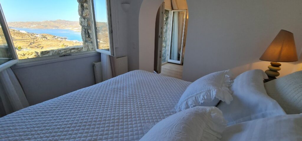 Comfy bedroom with an amazing view, the best private house in Mykonos rental villa.