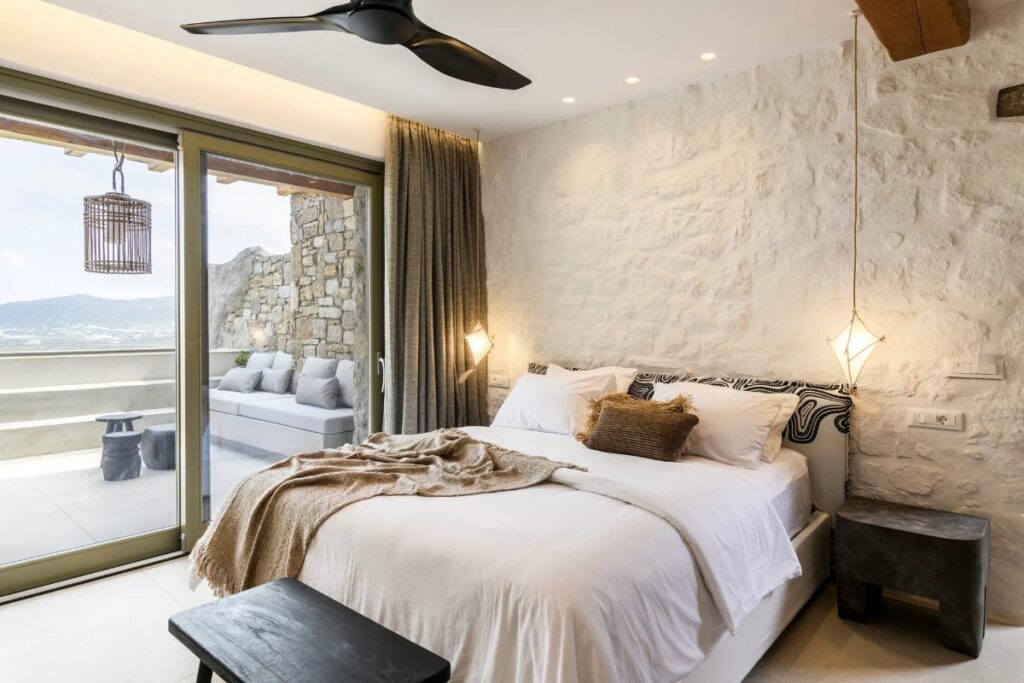 Creamy colors and soft design of a bedroom in Mykonos lavish villa for rent.