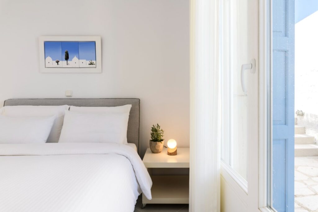 Stylish white bedroom in the best villa to stay in Mykonos.