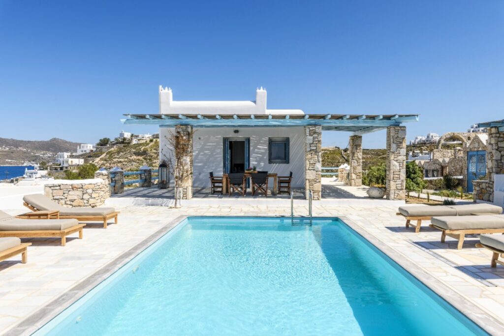 Chill-out space, cozy outdoor furniture, and a private pool in Mykonos villa for rent.