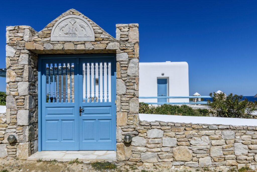 Blue gate which leads to a deluxe villa for rent, Mykonos.