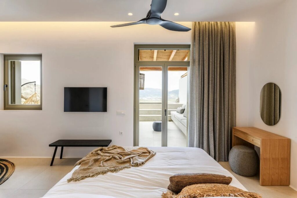 Modern bedroom with access to a terrace in Mykonos exceptional villa for rent.