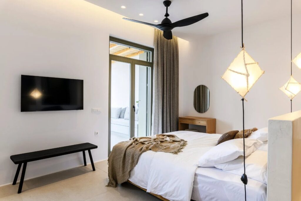 Modern lights and comfy beds in luxurious bedroom in the best rental home, Mykonos.