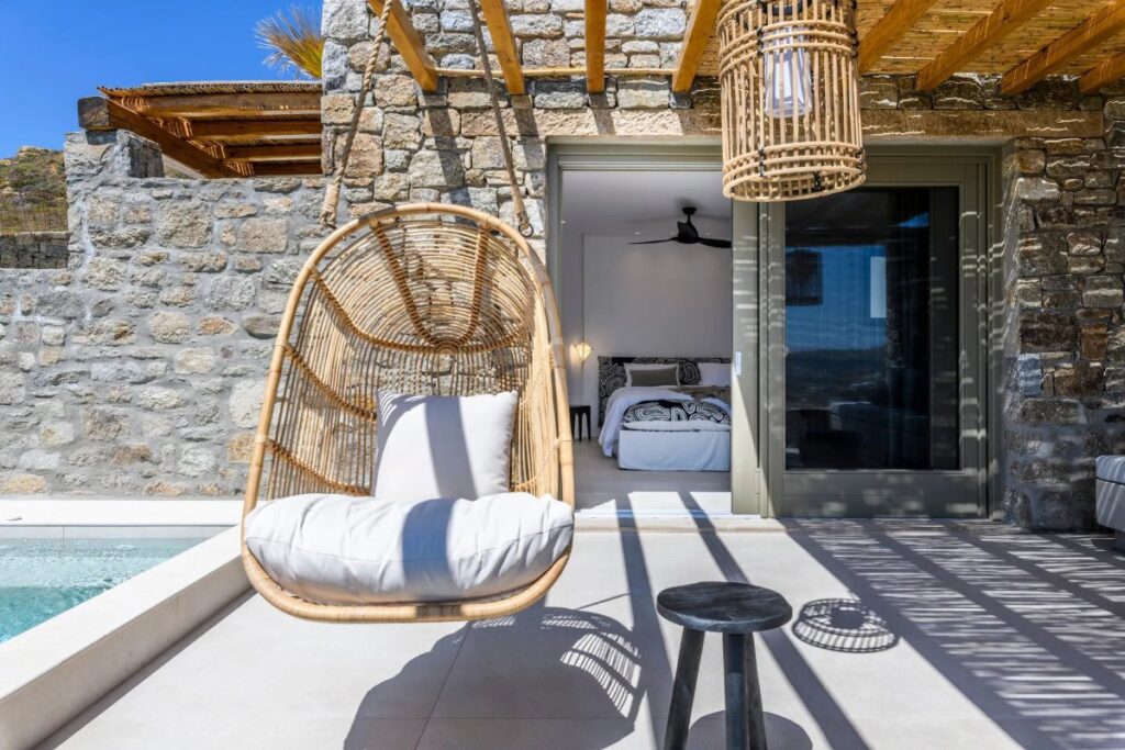Swing, garden, and bedroom in the lavish villa for rent, Mykonos.
