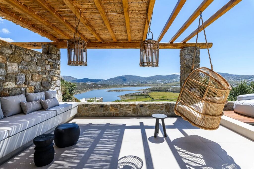 The Aegean sea, green nature, and enjoyable view from Mykonos lavish villa for booking.