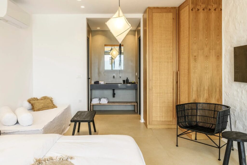 Bedroom with a modern bathroom in Mykonos finest rental home.