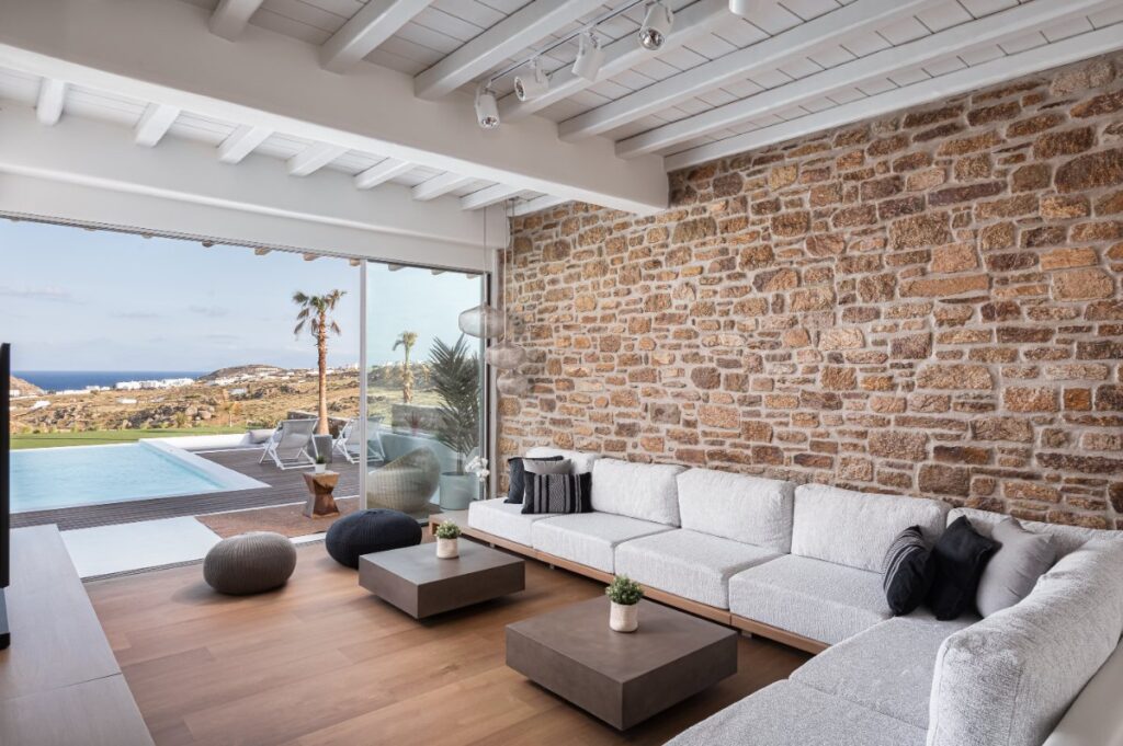 Inviting ambiance of our rental villa's living room with a view of the natural beauty of Mykonos.