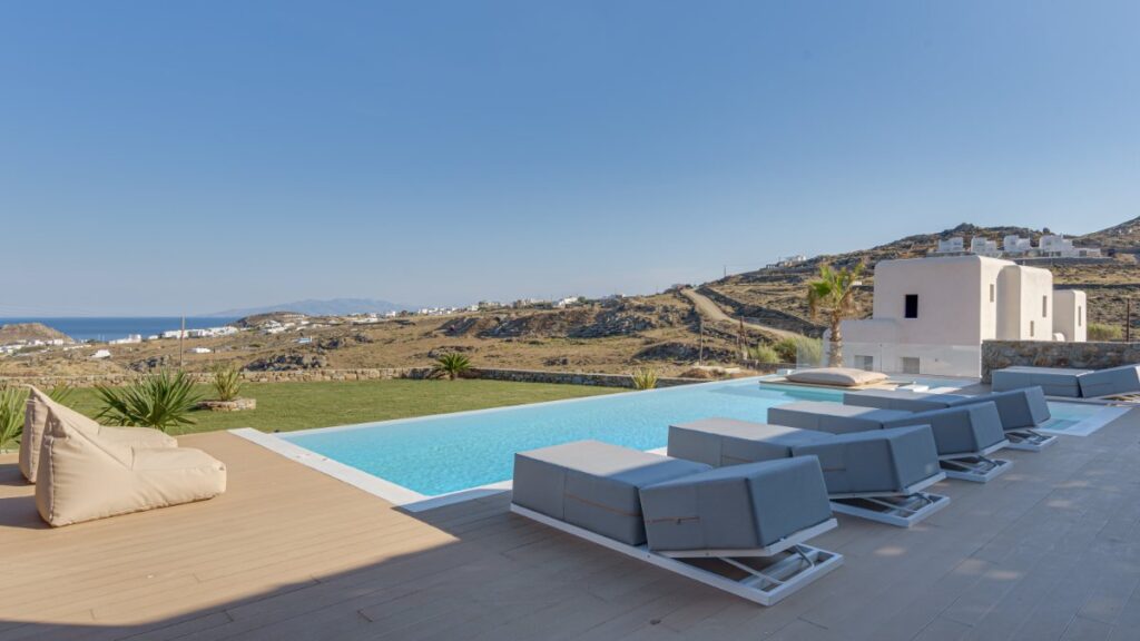 Waterfront villa with a luxurious yard and pool, ready for booking, Mykonos.