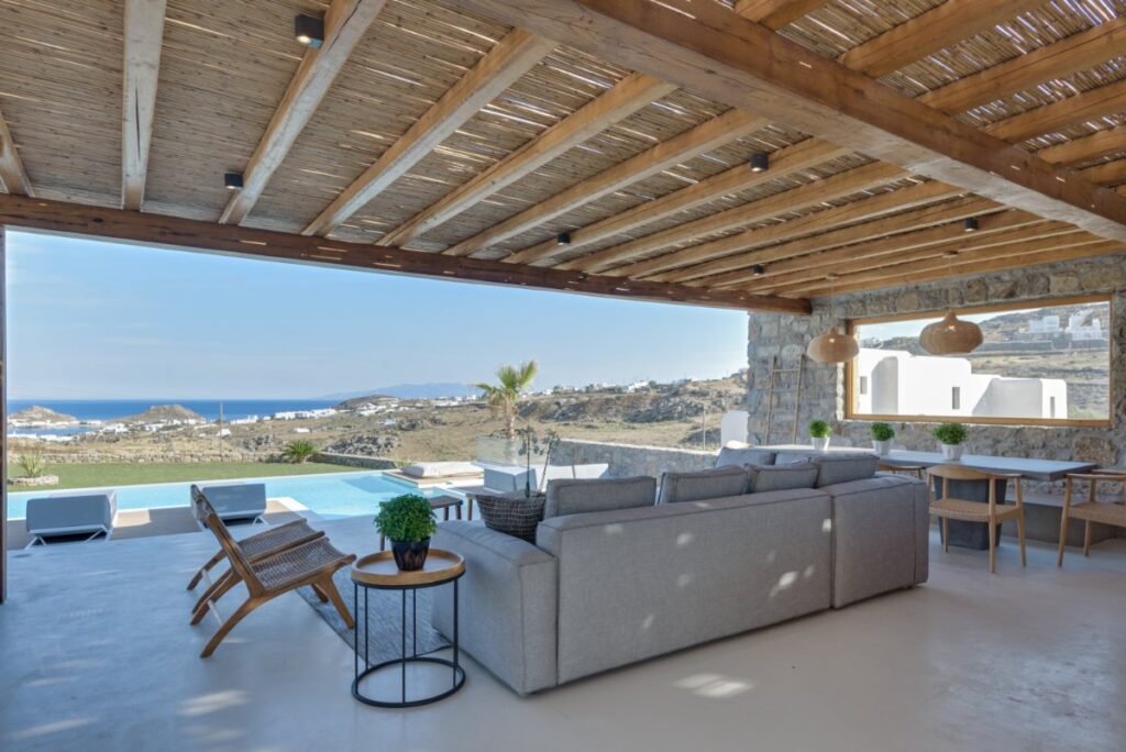 Furniture next to a lavish swimming pool in Mykonos exceptional villa for rent.