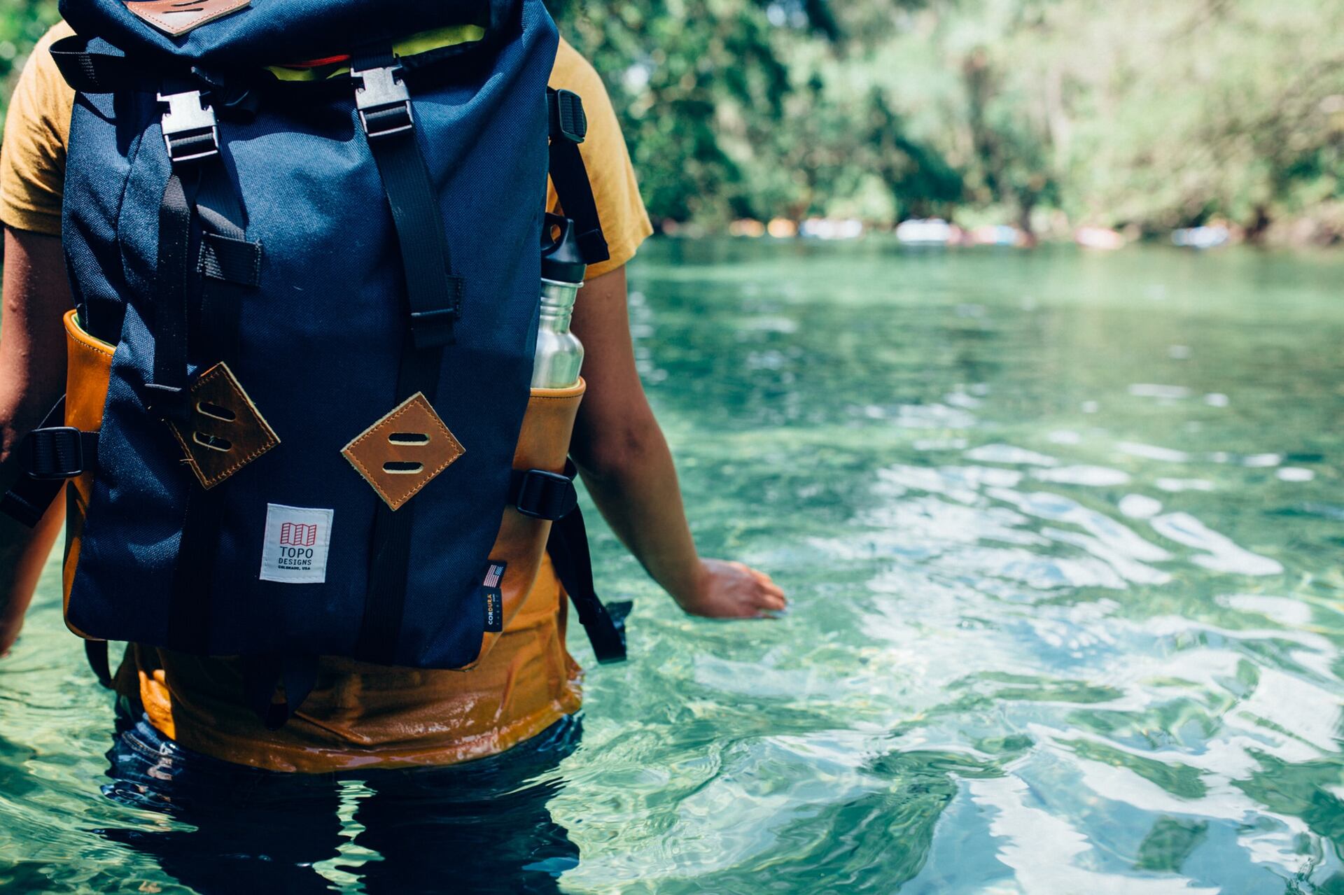 A man backpacking in water 