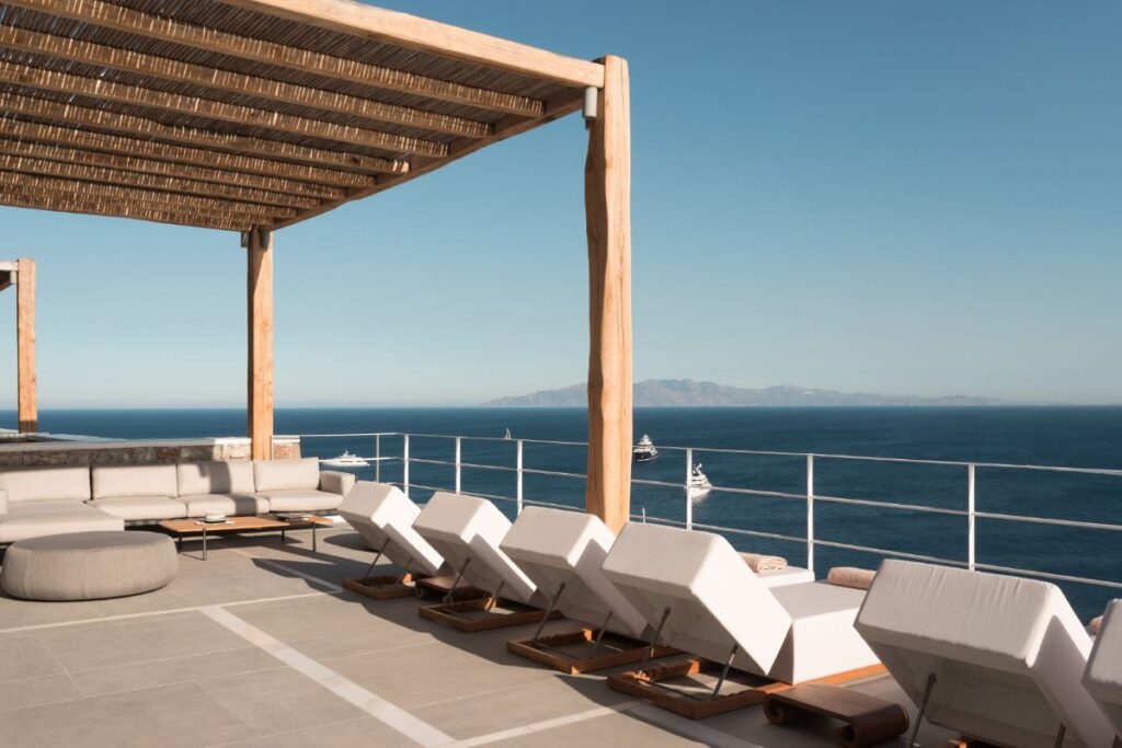 Sun beds and stunning view in Mykonos best rental villa.