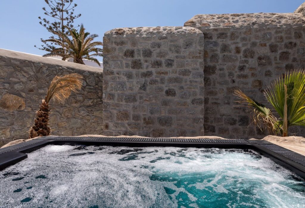 External Jacuzzi in the finest Mykonos villa for booking.