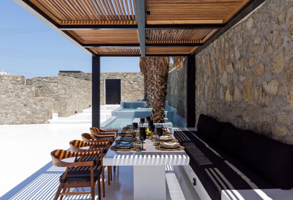 Dining table outside of splendid Mykonos villa ready for rent.