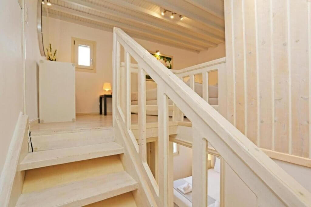Stairs and bedroom in the finest Mykonos villa for rent.