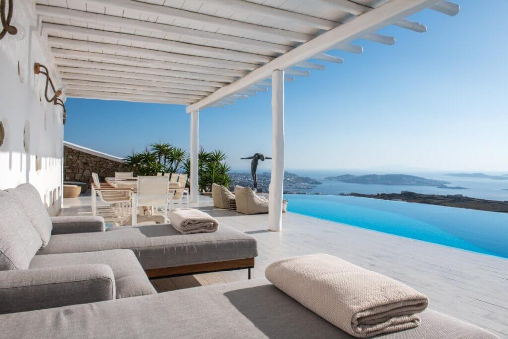 Terrace, swimming pool, and stunning view from the best Mykonos villa for booking.
