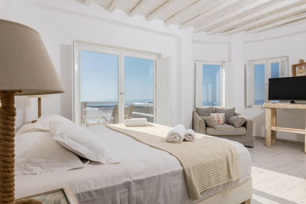 Lavish bedroom with an exquisite view of the sea in Mykonos rental villa, Greece.
