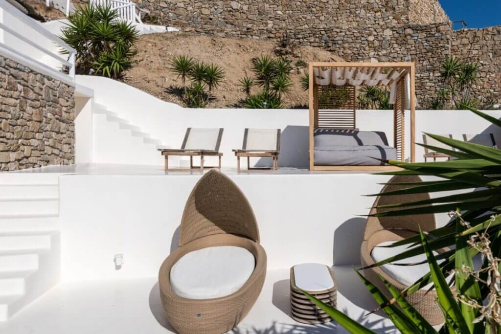 Sun beds and a luxurious oasis next to the pool in the finest Mykonos private house.