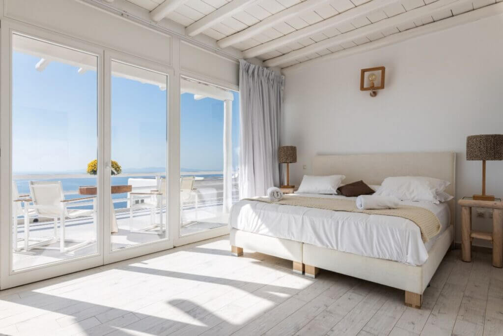 Bedroom showcasing a stunning sea view in the best villa in Mykonos, Greece.