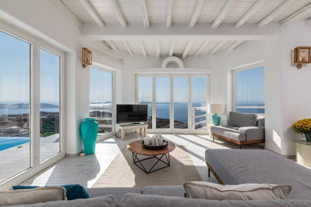 Waterfront living room with modern furniture in the top most luxurious villa for rent, Mykonos.