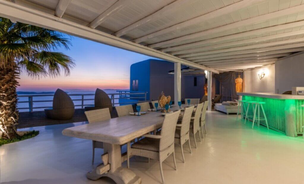 Dining table, bar at a terrace of Mykonos top private home for rent.