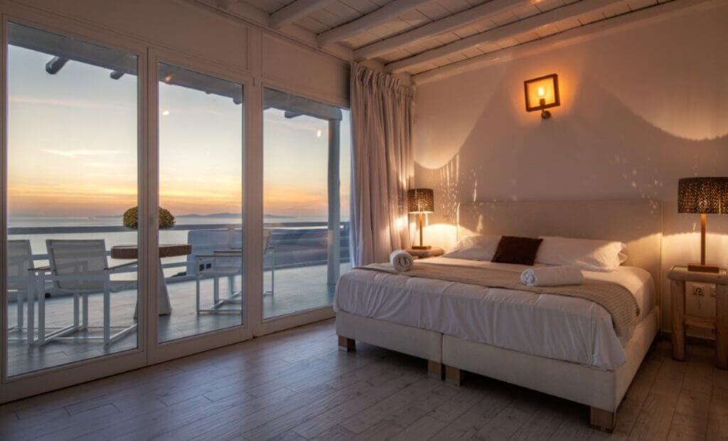 Bedroom, terrace, and sunset, Mykonos most lavish villa for rent.