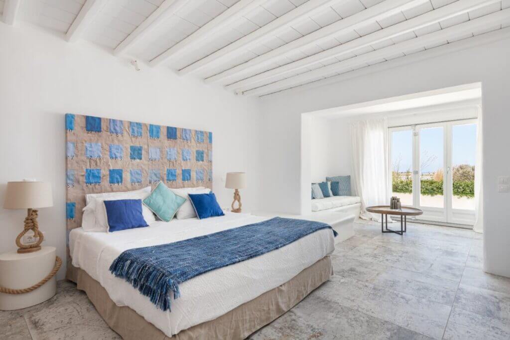 Spacious, blue and white bedroom in Mykonos villa for booking.