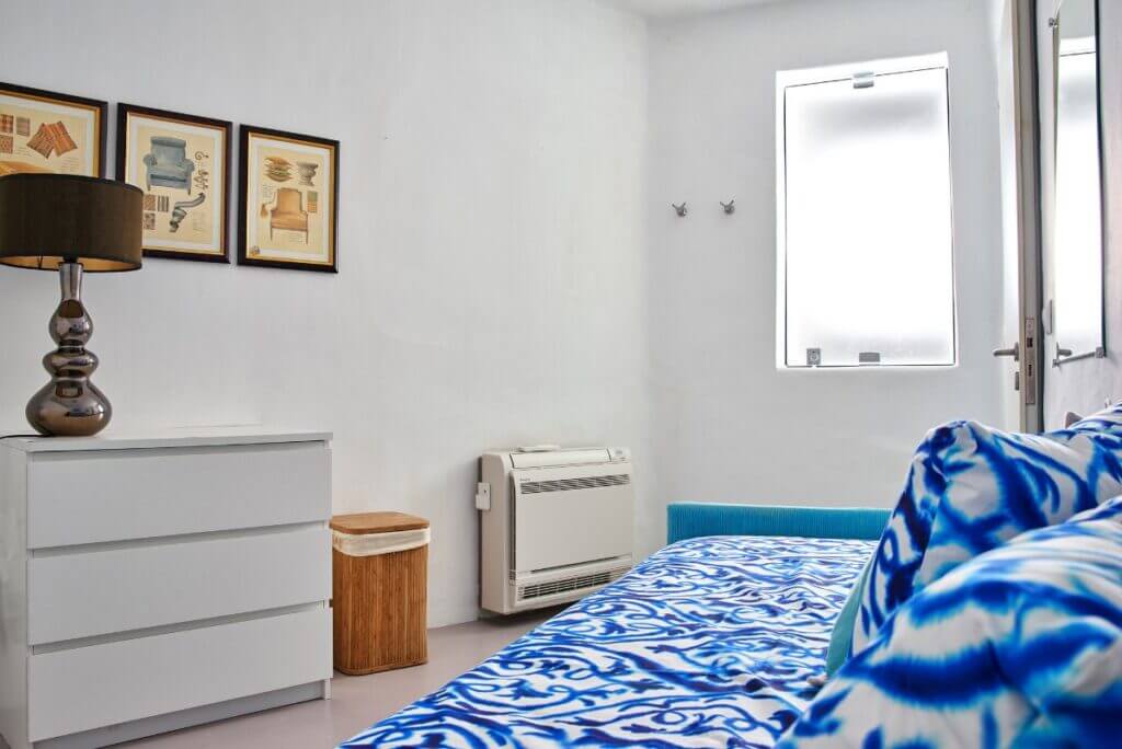 Cozy corner in a vibrant bedroom, Mykonos rental villa.