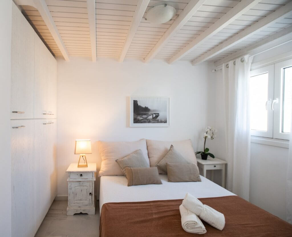Soft colors in a stylish bedroom of Mykonos top villa for rent.