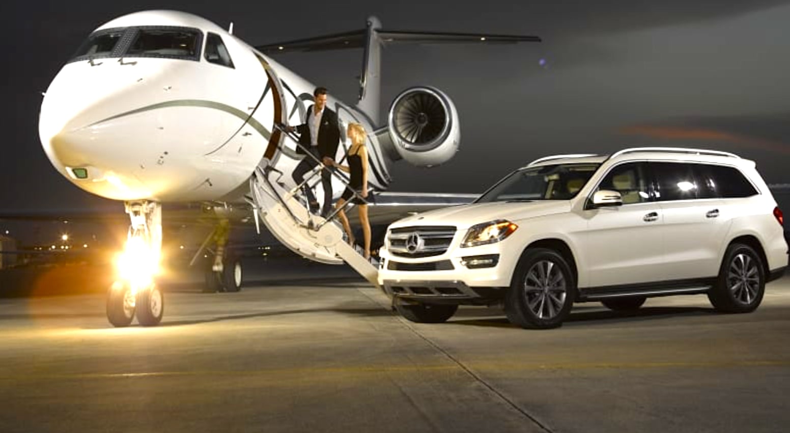 A luxury car next to a private jet rental in Mykonos