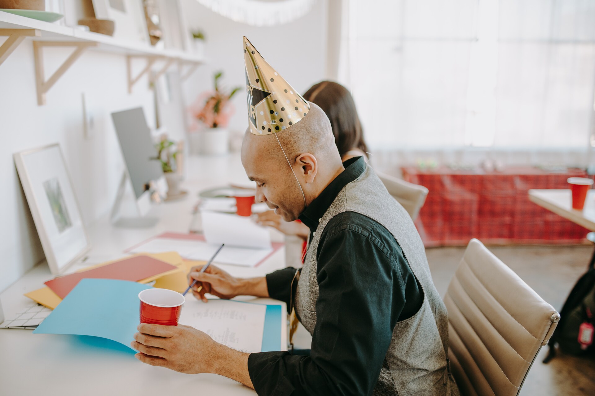 Man with a party hat planning an event