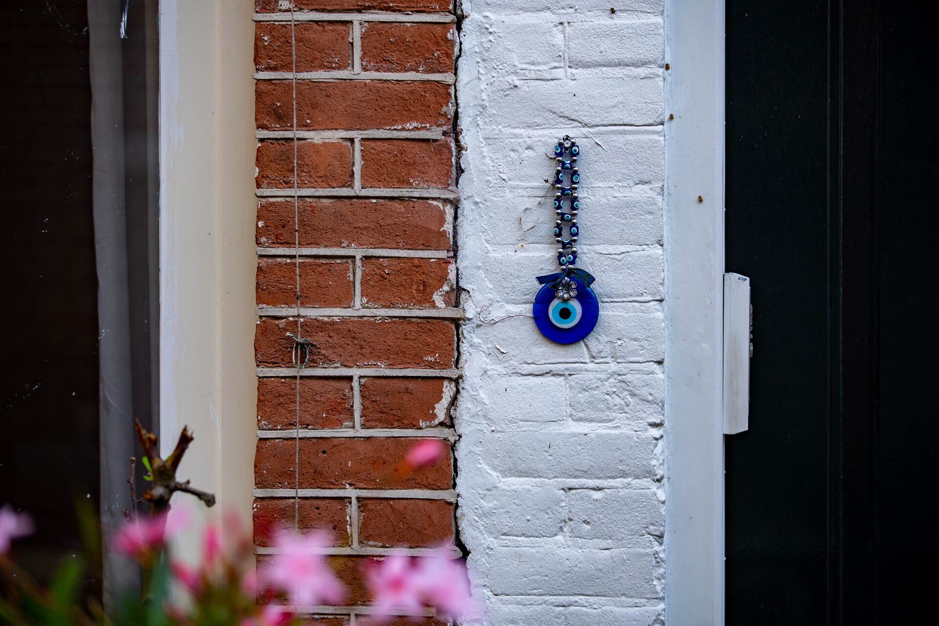 An evil eye charm hanging on a wall