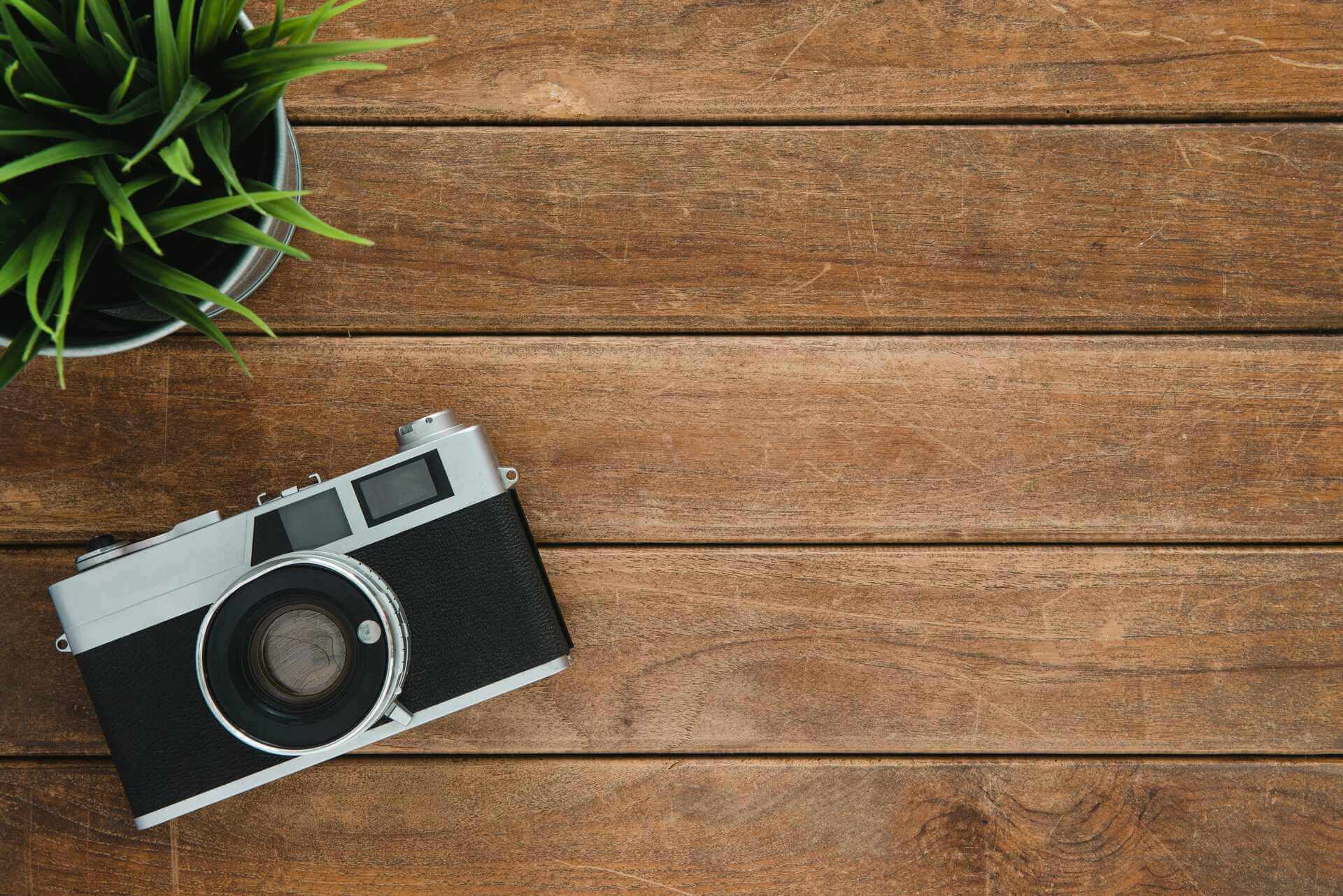  A camera on a wooden background