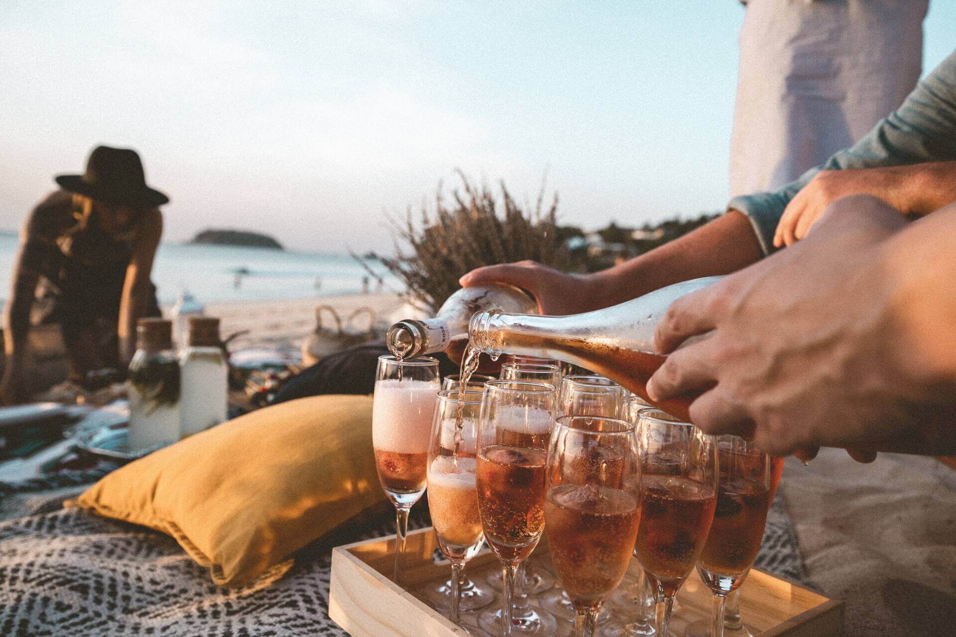 People drinking champagne on a beach 