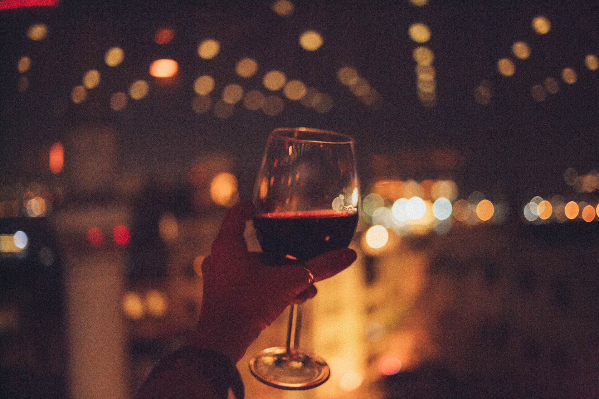 Person holding a glass of wine