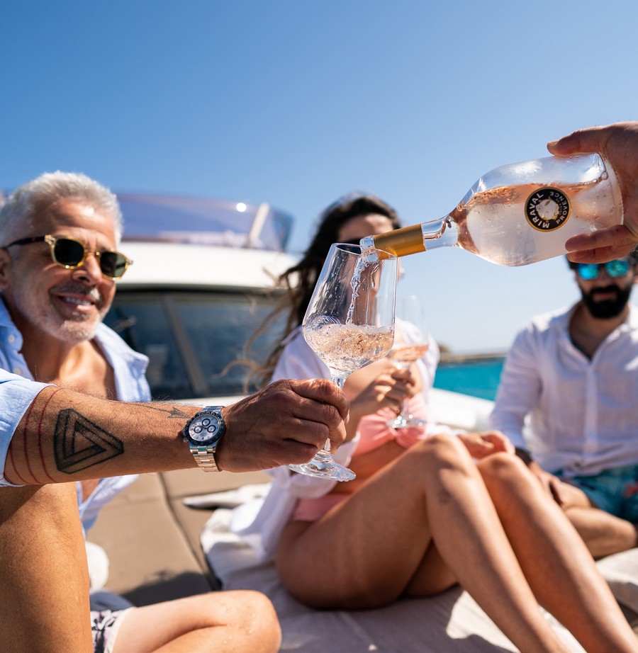 People drinking champagne on a yacht 
