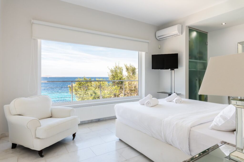 Bedroom with a sea view in the best rental villa, Mykonos.
